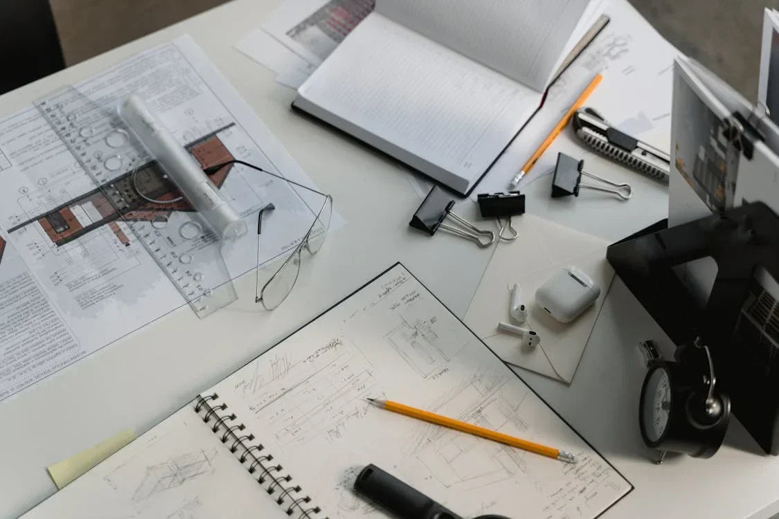 architect’s desk with plans and notebooks